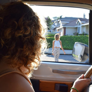 Young woman with a driver's license picking up her friend.