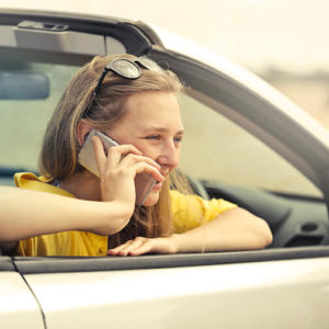 Young Woman with a driver's license in a new car